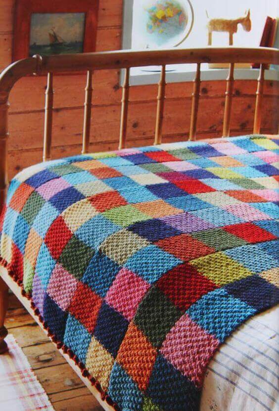 Colorful crochet bedspread for rustic bedroom