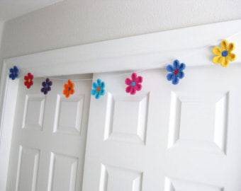 colorful crochet flowers on wire-white door-min