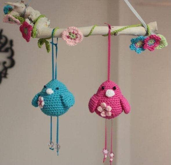 crocheted bird flowers on branch with min flowers