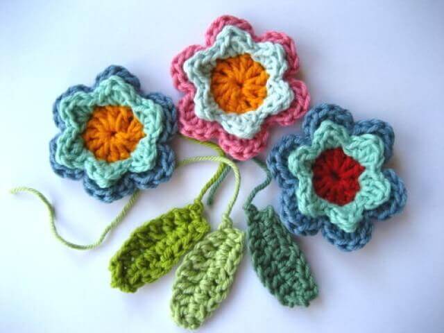 Colorful crochet flowers with leaves