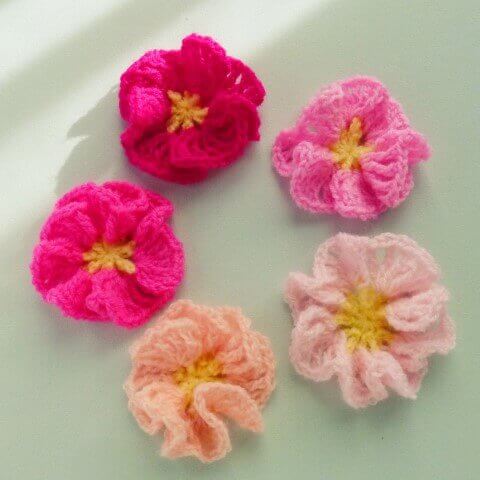 Crochet flowers in various shades of pink