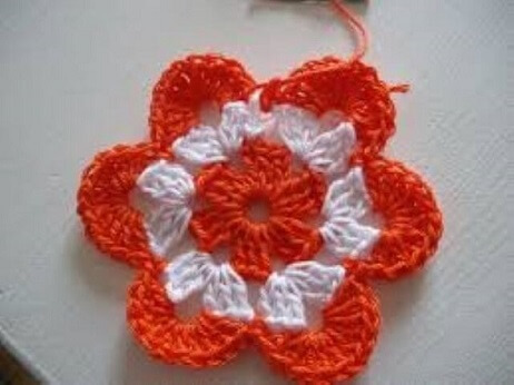 Orange crochet flower on white