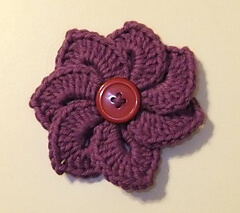 Purple crochet flower with button
