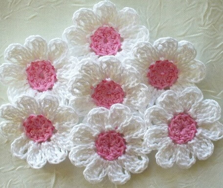 White crochet flower with pink centers