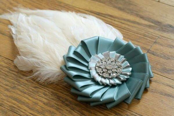 Satin ribbon flower with feathers and sparkles
