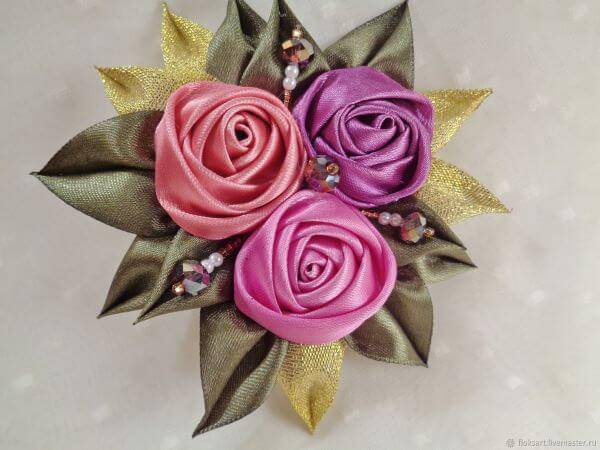 Satin ribbon flower with petals and golden details
