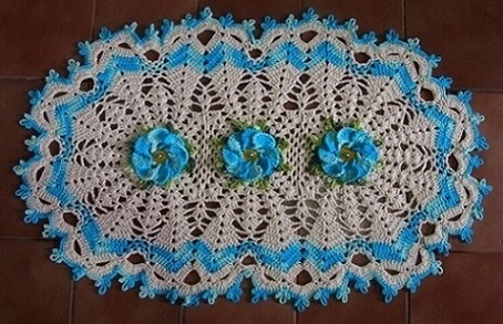 Oval crochet rug with blue flowers