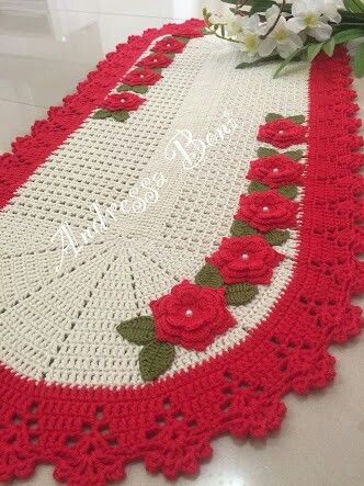 Oval crochet rug with red flowers