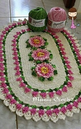 Oval crochet rug with light pink flowers