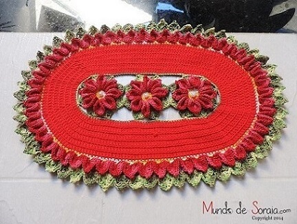 Red oval crochet rug with flowers