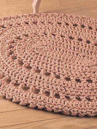 Pink and beige oval crochet rug