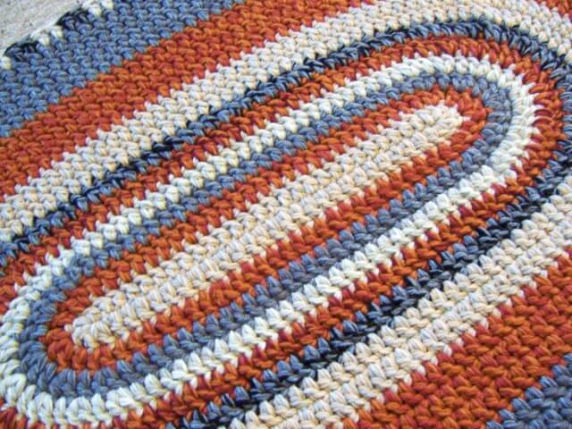 Orange and blue oval crochet rug