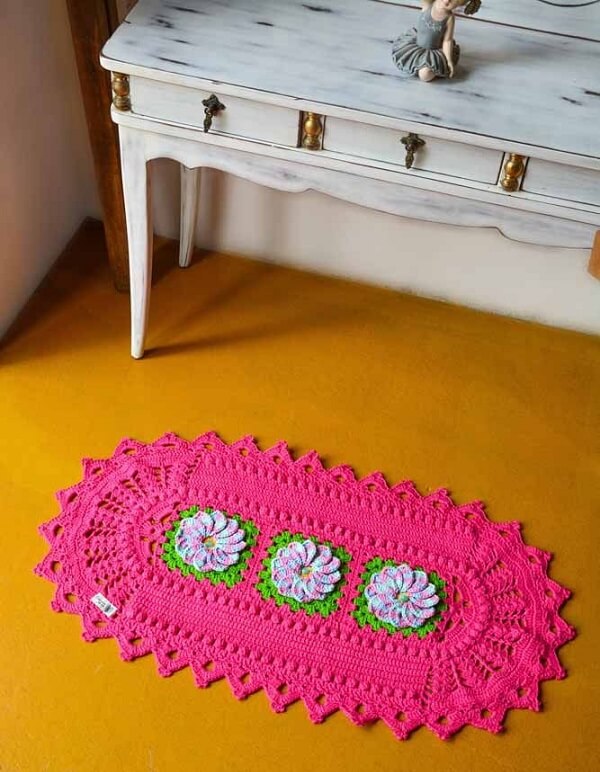 Pink crochet rug with delicate flowers