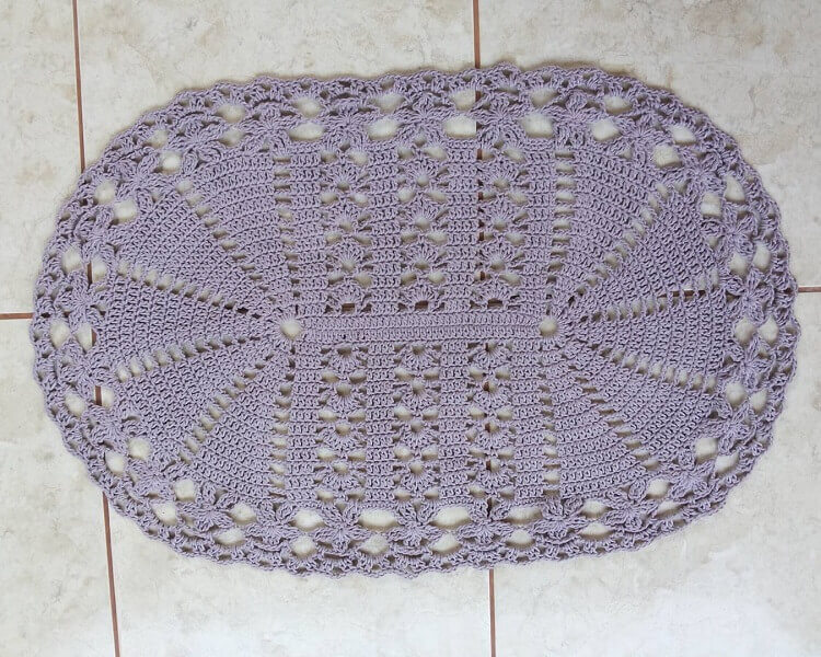 Oval crochet rug with neutral tone