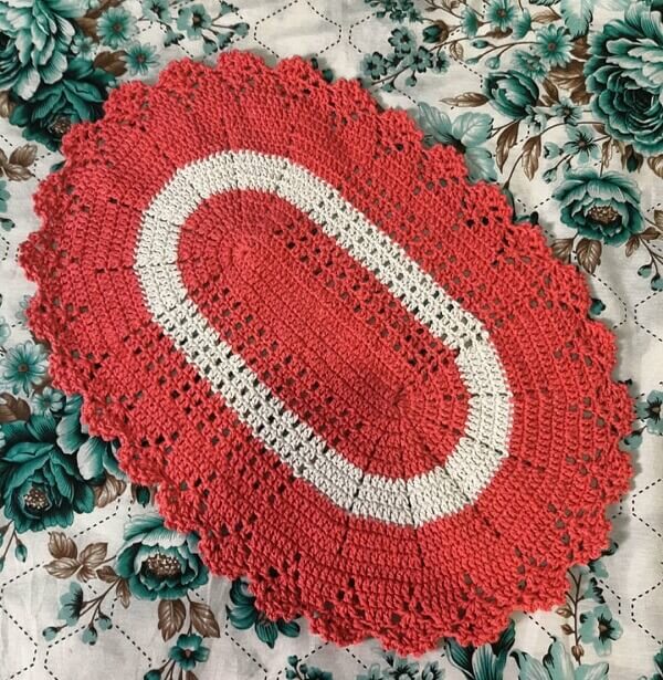 Red and white oval crochet rug