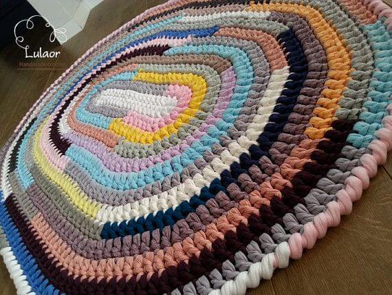 Colorful oval crochet rug with various colors