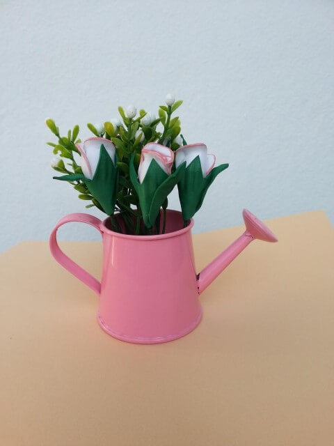 Arrangement with EVA flowers and pink watering can