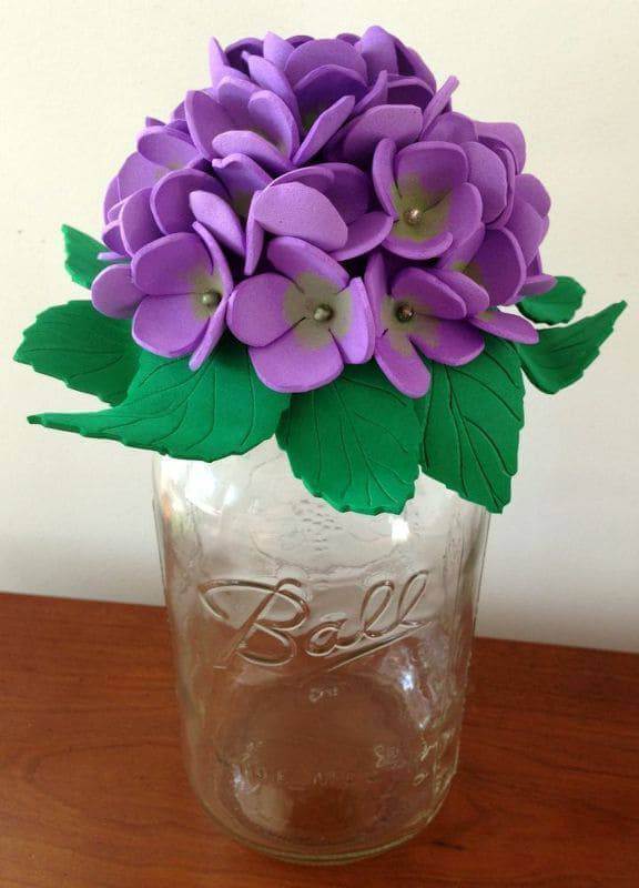 Purple EVA flowers in glass vase