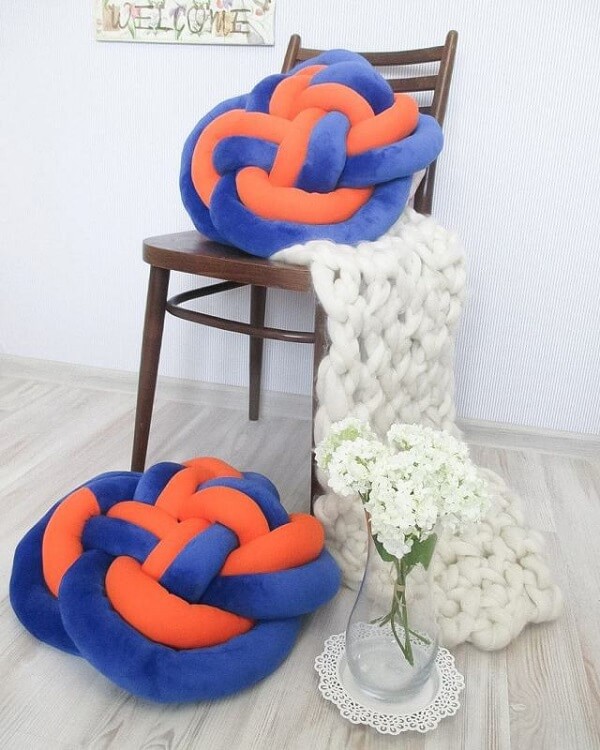 Mixed knot pillow in shades of orange and blue