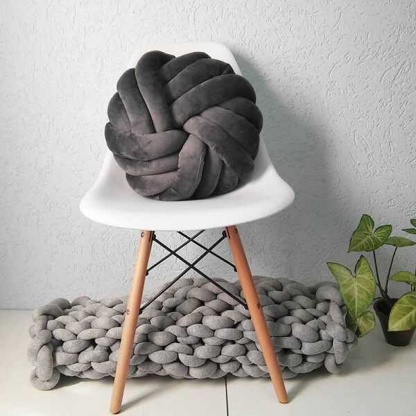 The black knot cushion stands out in the environment