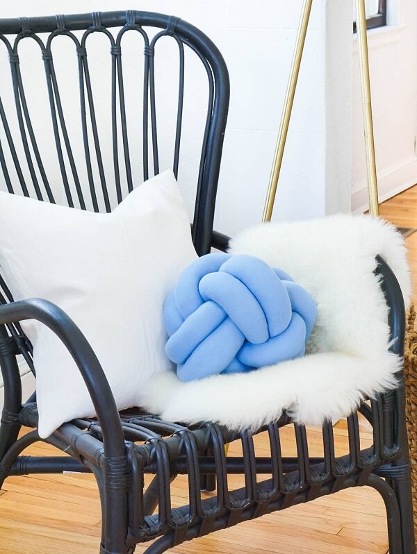 The blue knot cushion stands out on the chair