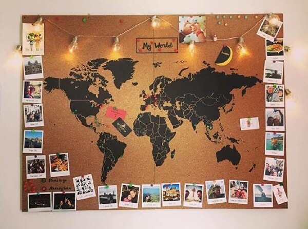 Corkboard with Polaroid photos and the design of the World Map
