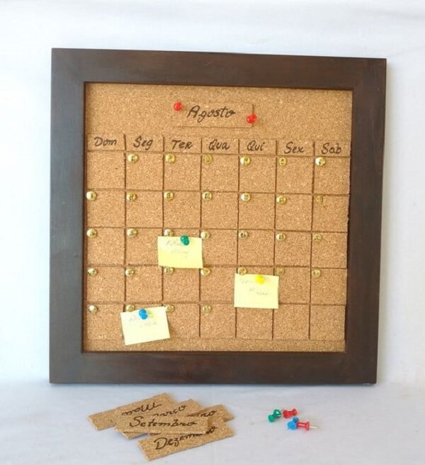 Cork board with brown frame serves as calendar