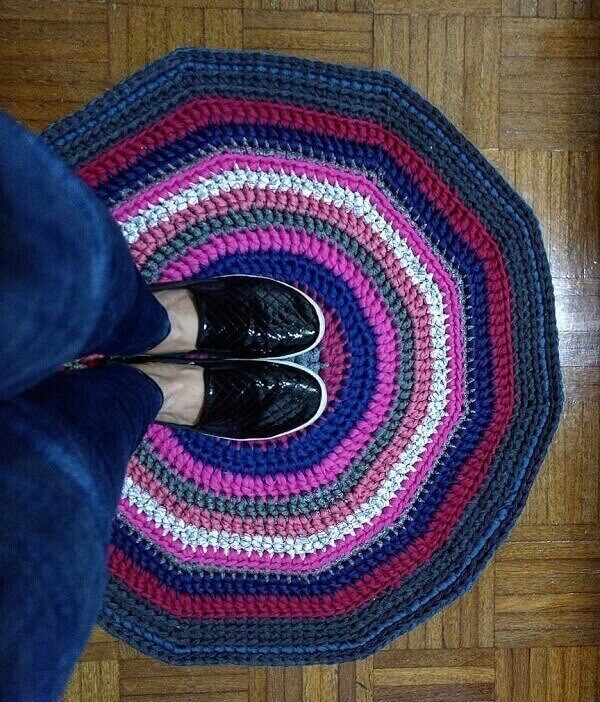 Place a round crochet rug with mixed colors