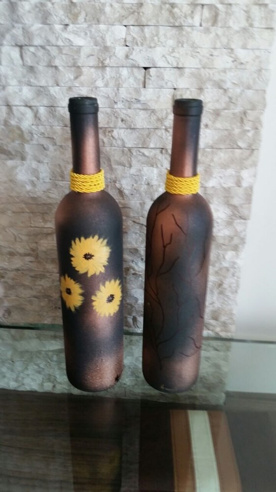 Bottles decorated with matte paint and painted flowers