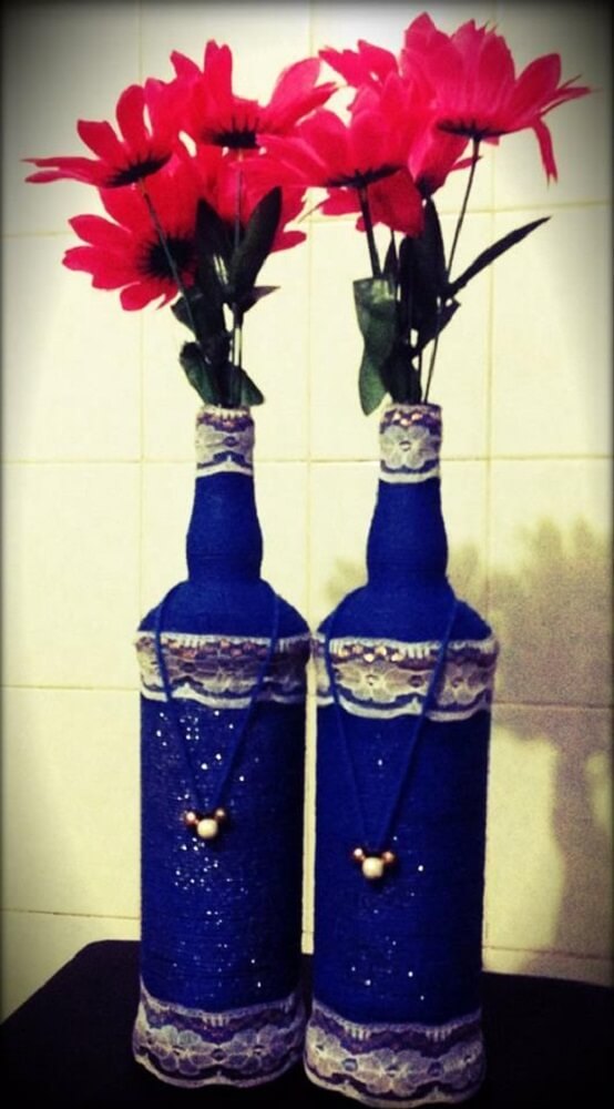 Bottles decorated with lace and painted blue