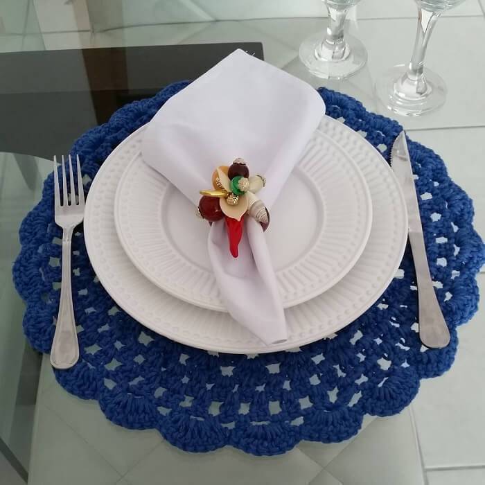 blue crochet sousplat with white dishes