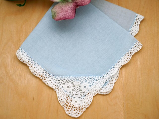 Blue tablecloth with white crochet nozzle Photo by Bumblebee Linens