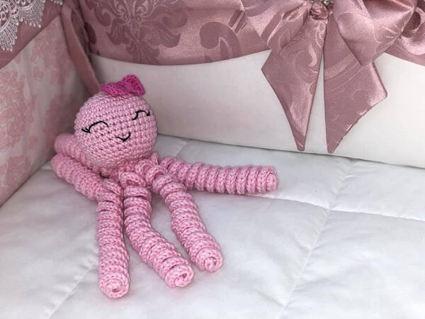 The crochet octopus was placed inside the crib
