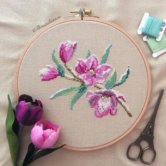 Flowers in cross stitch embroidery in shades of purple