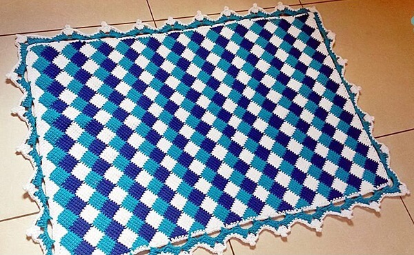 Rugs in shades of blue made with Tunisian crochet