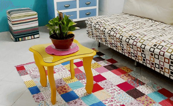 The room is much more colorful with the patchwork carpet