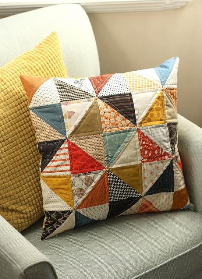 decor with colorful patchwork cushion and gray armchair