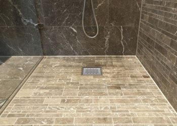 Do I need to waterproof concrete floor before tiling?