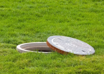 why does my septic tank backup when it rains