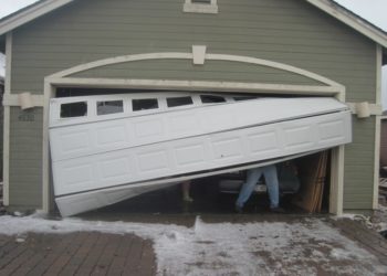 How do you fix a bent metal garage door?
