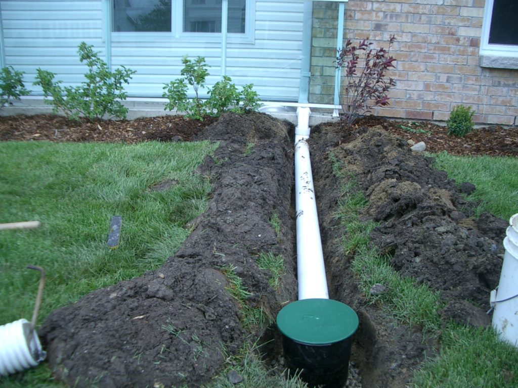 Do holes go up or down in a French drain?