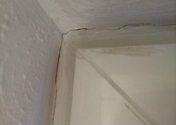 hairline cracks where wall meets ceiling