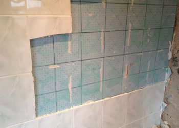 can u tile over painted walls