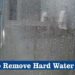 What removes hard water stains from glass shower doors?