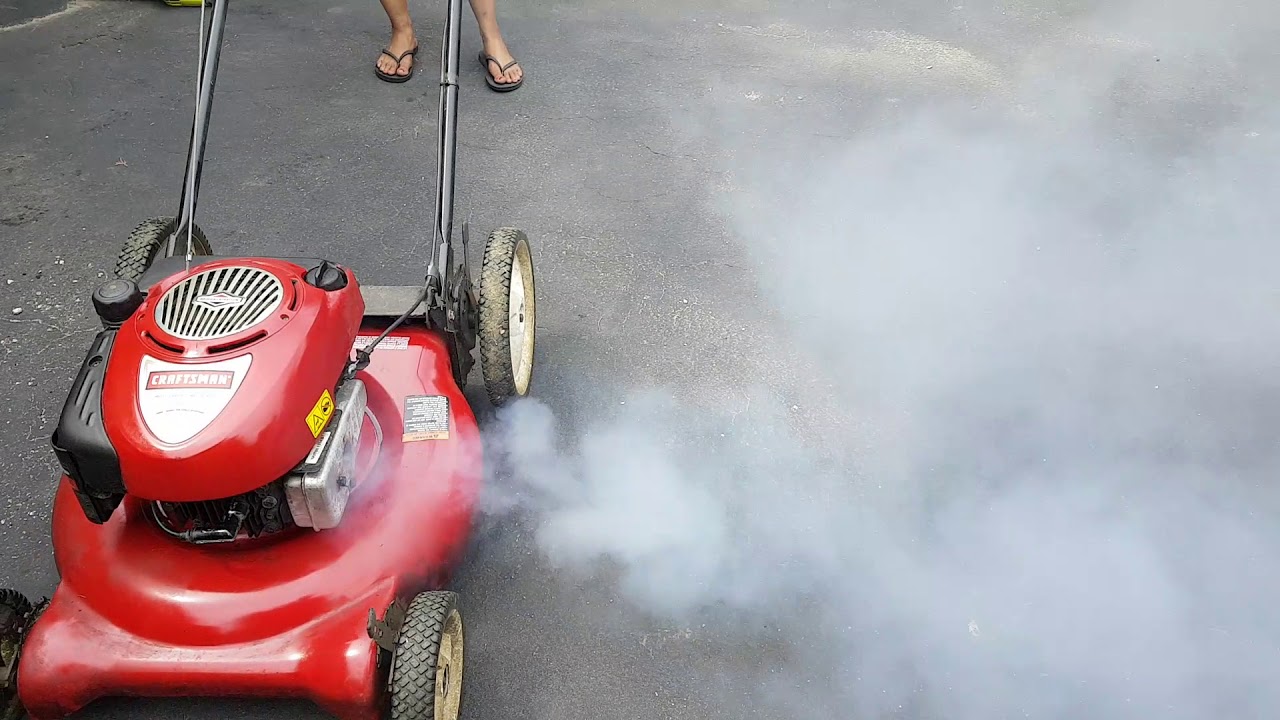 How do I fix white smoke from my lawn mower?