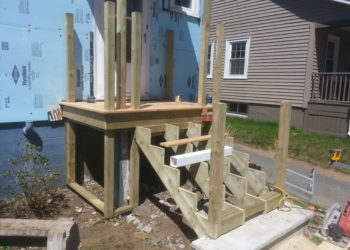 How do you attach a railing to concrete steps?