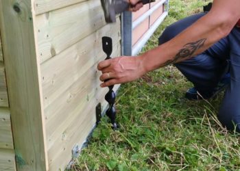 How do you anchor a steel building to the ground?