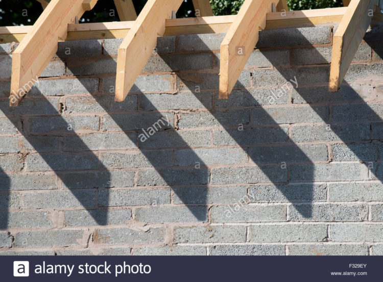 How do you attach a roof to a concrete block wall?