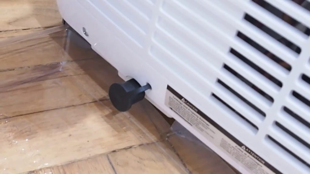 How do you drain a portable air conditioner with a hose?