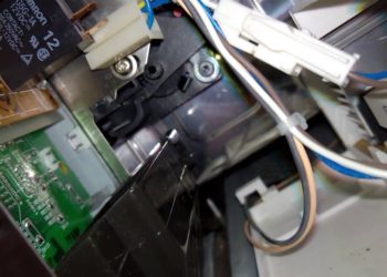 How do you fix a stuck microwave door latch?